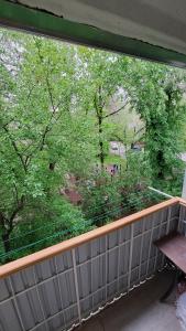 a window of a balcony with a view of trees at MargoHome in Almaty