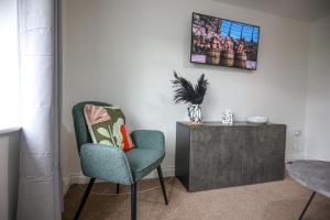 a living room with a chair and a cabinet at Cozy 1-BR Sanctuary in Redland, Bristol in Bristol