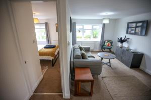 a living room with a couch and a bed at Cozy 1-BR Sanctuary in Redland, Bristol in Bristol