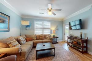 a living room with a couch and a ceiling fan at Friends Delight in Calabash