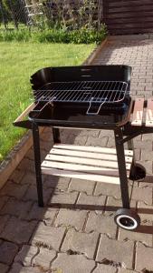 a barbecue grill sitting on a brick patio at Dom Wakacyjny JM in Prudnik