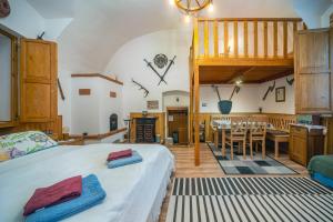 a bedroom with a bed and a dining room at Kordé Apartman in Kőszeg