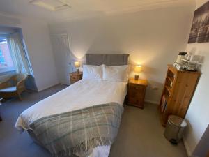 una camera con un letto con due comodini e due lampade di Orchard Views a North Hykeham