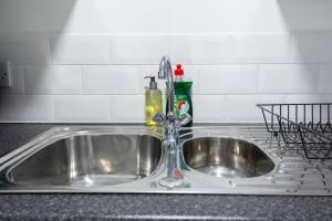 a kitchen sink with a faucet on a counter at Charming 1-BR Hideaway on bristol in Bristol