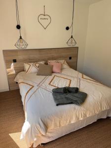 a bedroom with a bed with a hat on it at La forêt in Plan-de-la-Tour +9 photos