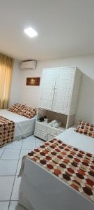 a hotel room with two beds and a checkerboard pattern at Villa Domenico in Salvador +253 photos