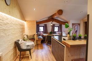 a kitchen and living room in a house with wooden beams at Chalet Aignerhof in Flachau