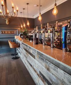 un bar con bancone in legno in un ristorante di The Ryebeck Hotel a Bowness-on-Windermere