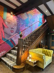 a room with a staircase with a mural at The Ryebeck Hotel in Bowness-on-Windermere