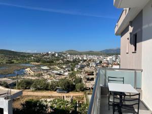 a balcony with a table and chairs on a building at Vila Olserd Shehu in Ksamil