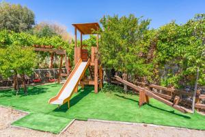 a playground with a slide in a park at Villa Kiotari Ariti in Kiotari