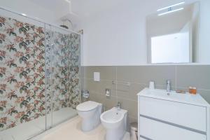 a bathroom with a toilet and a sink at Dimore delle Zagare Molo in Syracuse