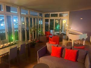 a living room with a couch and a piano at Eco Hotel Cleofe in Caorle