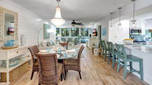 a dining room and kitchen with a table and chairs at 1166 PD Contemporary Coastal Luxury in Siesta Key