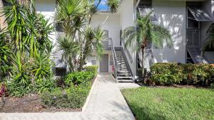 a house with palm trees and a stairway at 1166 PD Contemporary Coastal Luxury in Siesta Key