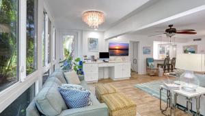 a living room with a couch and a desk at 1166 PD Contemporary Coastal Luxury in Siesta Key