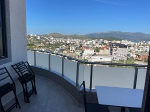 a balcony with a table and chairs and a view at Vila Olserd Shehu in Ksamil
