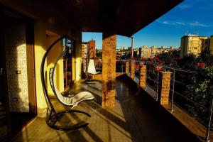 a bench on a balcony with a view of a city at Silver in Hunedoara
