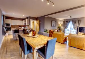 a kitchen and living room with a table and chairs at 6 Mariners Point in Hartlepool