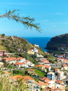 a village on a hill with the ocean in the background at CASA Bela Vista in Machico
