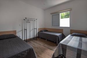 um quarto com duas camas e uma janela em Espaco Bom Viver em Jundiaí