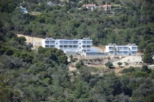 a large white building on top of a hill at AKAMAS THRONE APARTMENTS in Neo Chorio