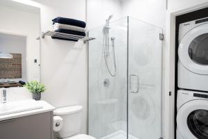 a bathroom with a shower and a washing machine at Summit Views Condo by Revelstoke Vacations in Revelstoke +30 photos