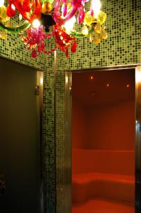 a bathroom with a tub and a mirror and lights at Eco Hotel Cleofe in Caorle