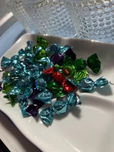 a pile of colorful glass beads on a white plate at The Coffee Residences- 3 Bedroom Apartments-4km to JKIA, 7km to CBD in Nairobi