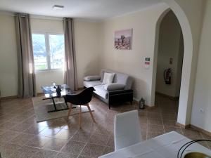 a living room with a couch and a table at CASA Bela Vista in Machico