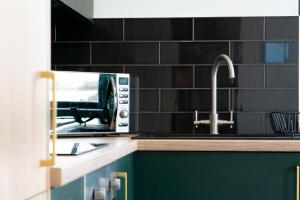 a kitchen counter with a toaster and a sink at Midsummer House Apartments "Free On-Site Parking & Sky TV" in Peterborough
