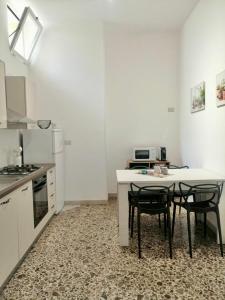 a kitchen with a table and two chairs in it at La Casa verde in Galatone