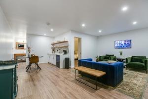 a living room with a blue couch and a kitchen at Angoria Hotel in San Angelo