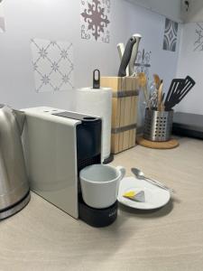 a microwave sitting on a counter with a cup and aucer at Penzión Pod Guglom in Mlynky 