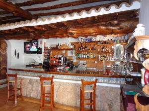 a bar in a restaurant with wooden ceilings at Apartamentos Los Pinares Benet in Santa Eularia des Riu
