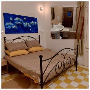 1 dormitorio con 1 cama y baño con lavamanos en Cactus & Mandala en Birżebbuġa