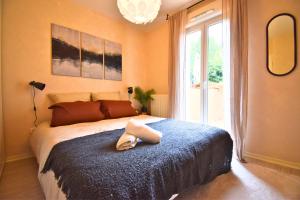 a bedroom with a bed with a towel on it at Oasis SPA Bath et Jardin Parisien in Aubervilliers