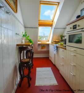 a small kitchen with a red floor and a window at Sea & City 50 m Monte Casinno 100 m Beach Apartments Lux Sopot in Sopot
