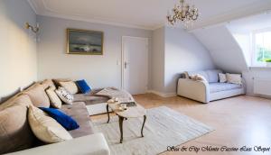 a living room with a couch and a table at Sea & City 50 m Monte Casinno 100 m Beach Apartments Lux Sopot in Sopot +31 photos