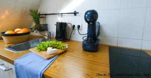 a kitchen counter with a cutting board with green grapes at Sea & City 50 m Monte Casinno 100 m Beach Apartments Lux Sopot in Sopot