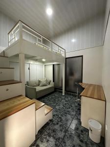 a living room with a loft bed and a couch at Casa Buen Agüero in San Antonio