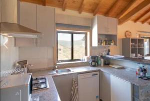 a kitchen with a sink and a counter top at Grande Vista Douro in Valença do Douro