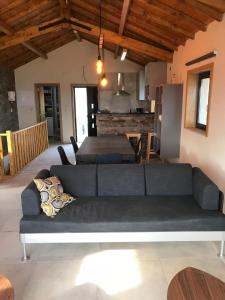 a living room with a couch and a kitchen at Grande Vista Douro in Valença do Douro