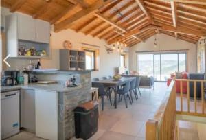 a kitchen and dining room with a table and chairs at Grande Vista Douro in Valença do Douro