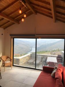 a living room with a large window with a view at Grande Vista Douro in Valença do Douro