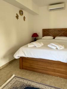 a bedroom with a large bed with white sheets at Betul Guest House in Famagusta