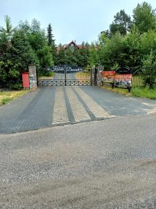 a gate on the side of a road at Kalski Dworek in Węgorzewo