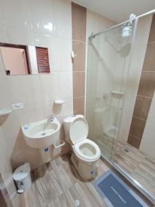 a bathroom with a toilet and a sink and a shower at Paiparadise 402 in Paipa