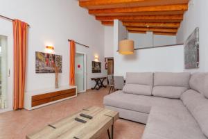 a living room with a couch and a table at Villa Casa Xaloc in Binibeca