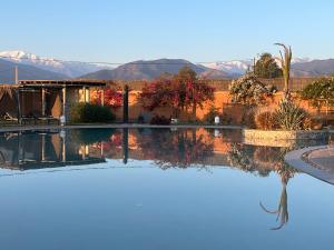 a pool with a view of the desert and mountains at Dar Tiziri Amizmiz in Marrakech